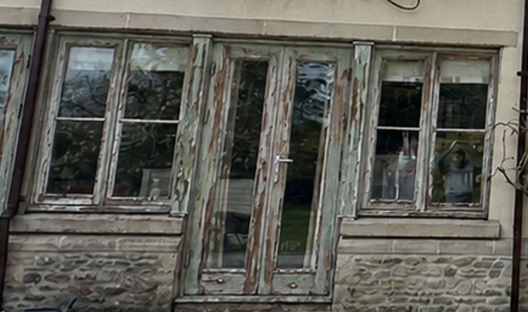 Close-up of weathered sash windows and doors before restoration